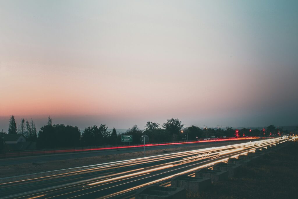 Light trails of traffic on William Nicol Drive in Fourways, Johannesburg, at dusk