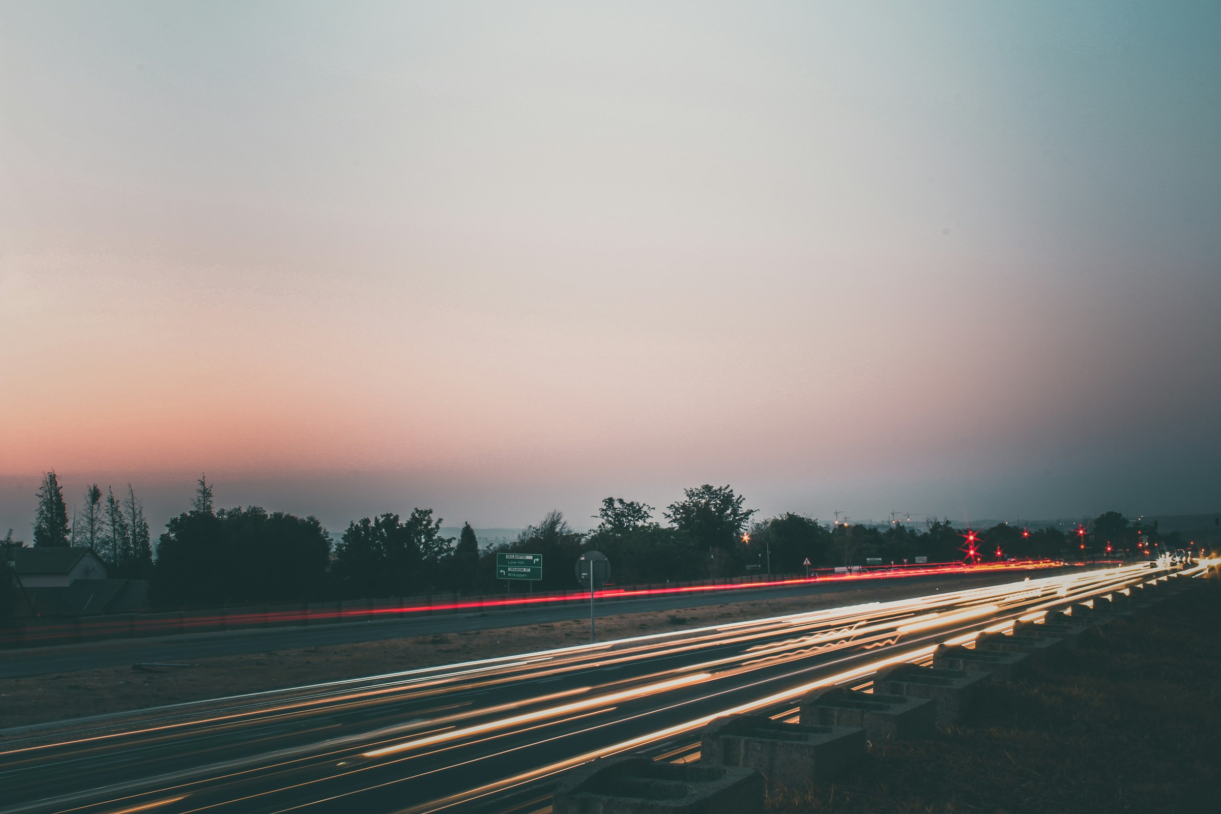 Light trails of traffic on William Nicol Drive in Fourways, Johannesburg, at dusk
