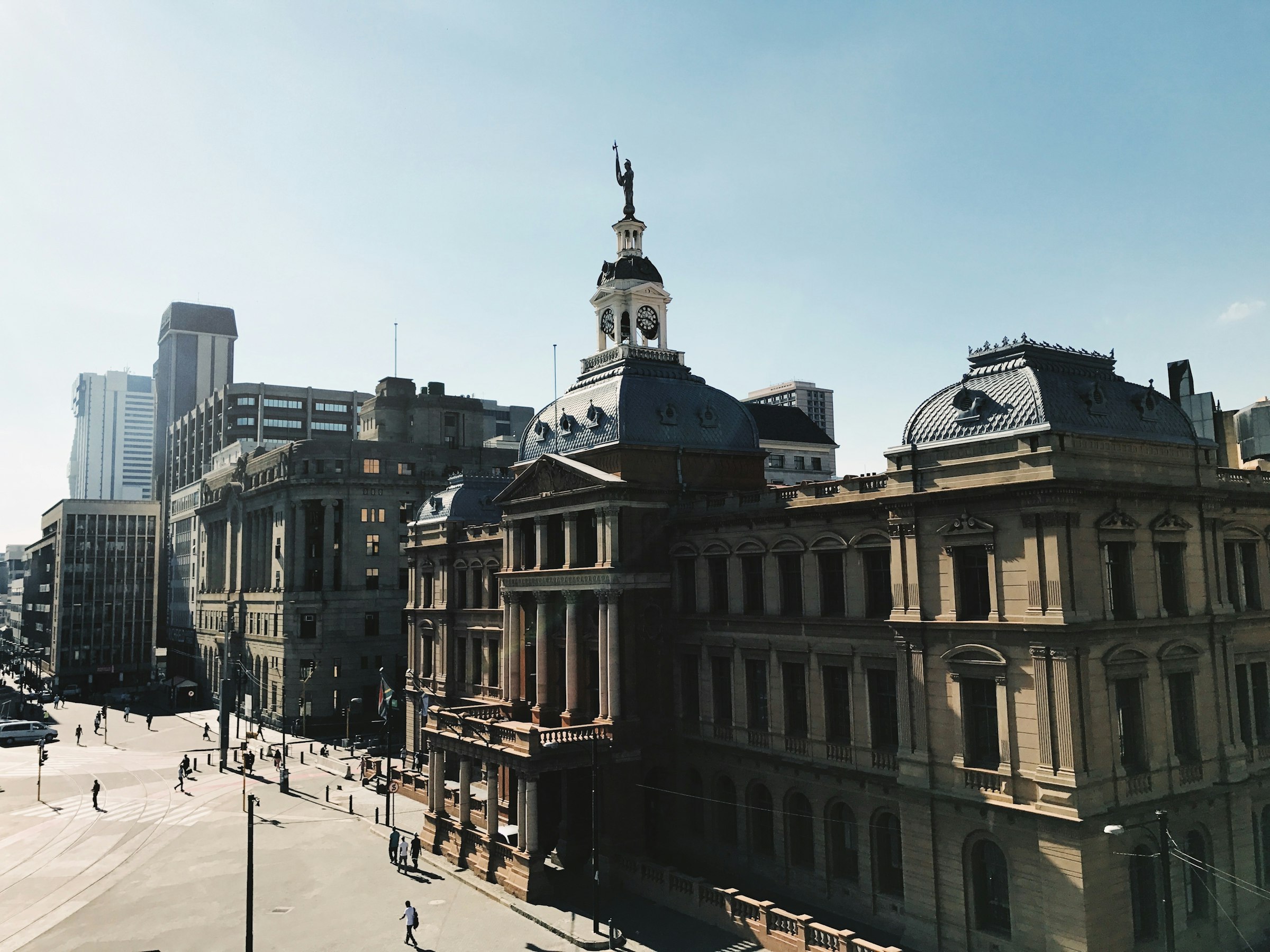 The Palace of Justice on Church Square in Pretoria, with people walking across the square in morning light